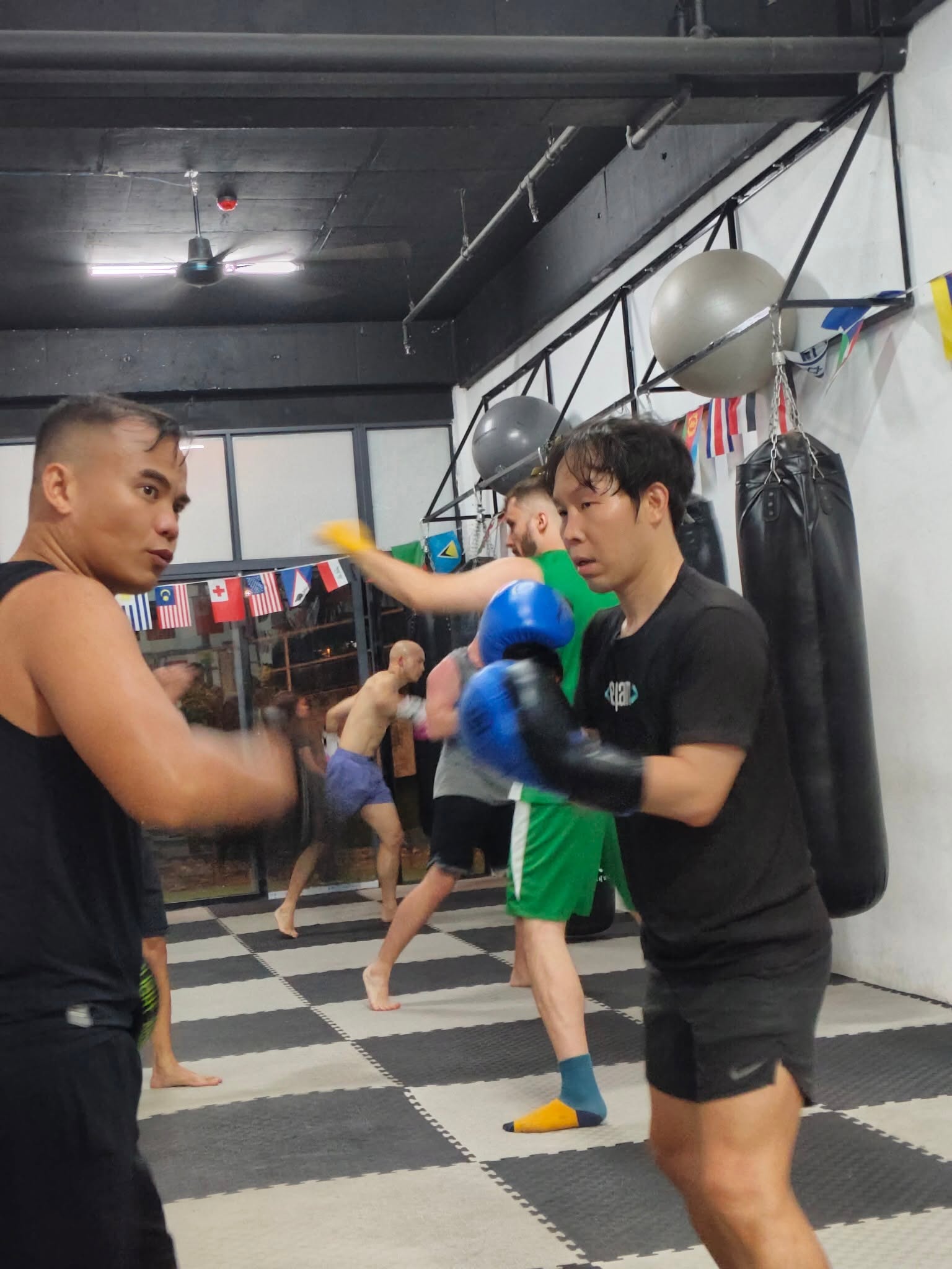 A member practising boxing combinations with a coach at Knock'ls